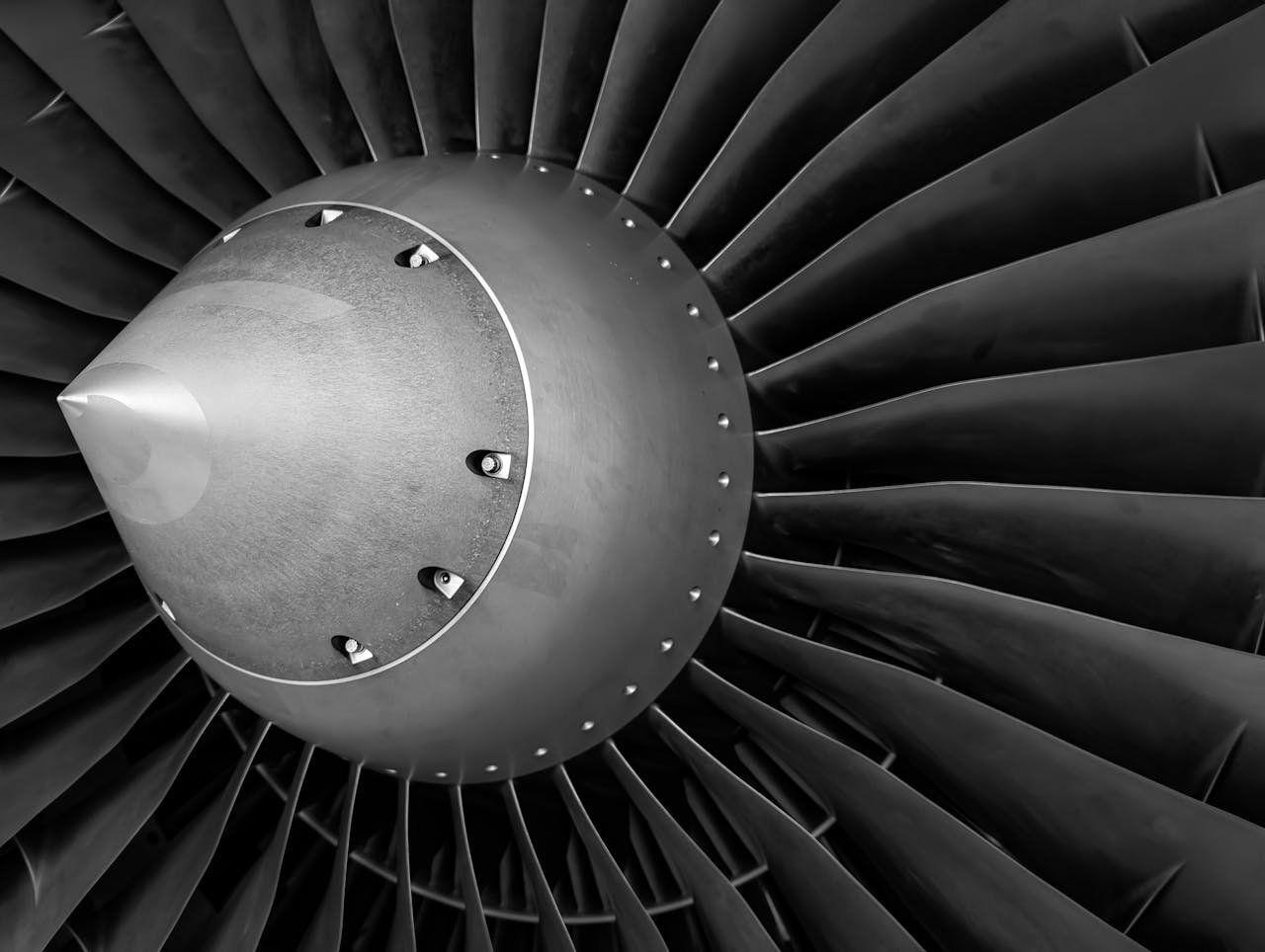 Detailed close-up of an aircraft jet engine turbine showcasing mechanical engineering precision.